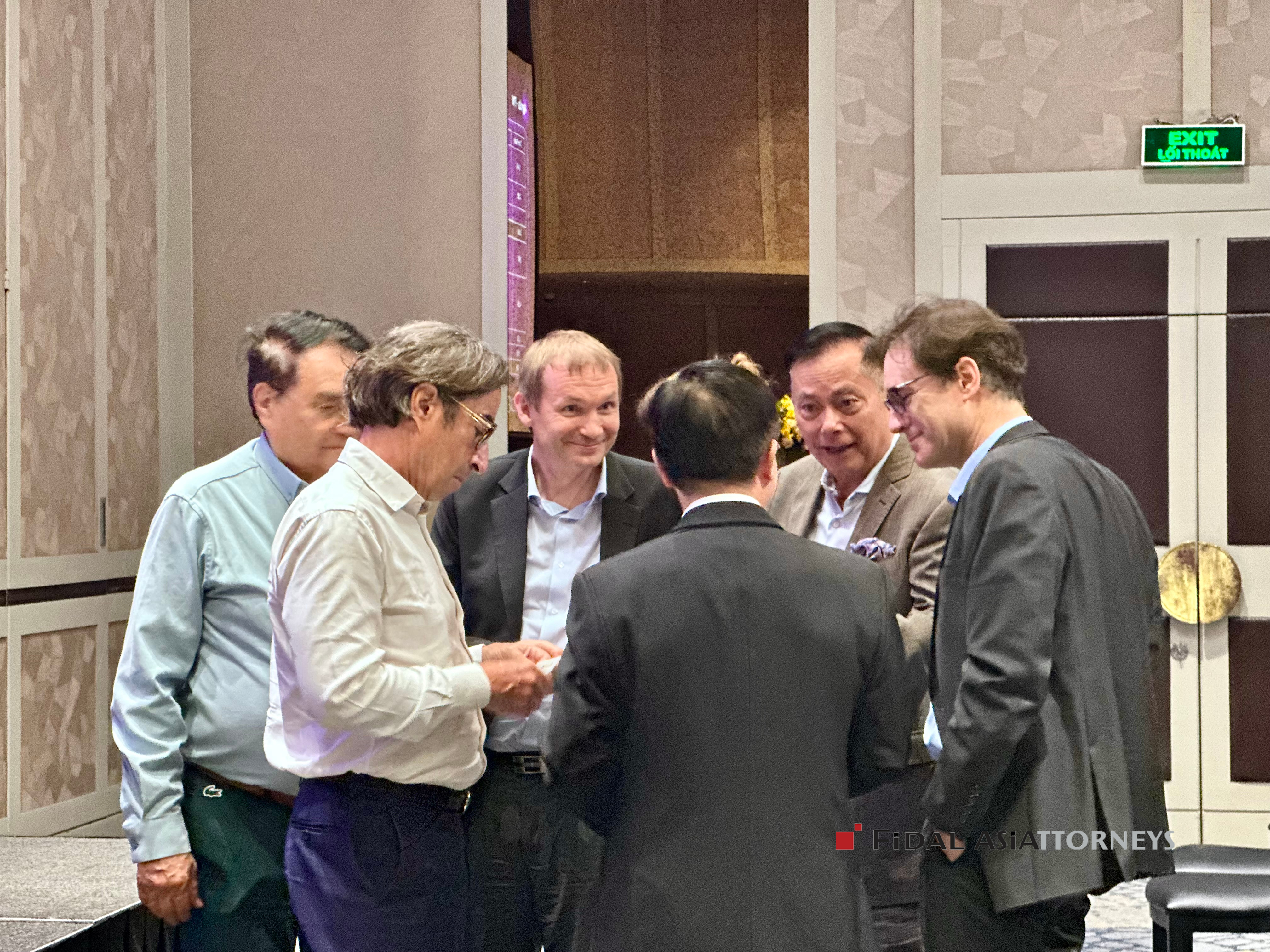 Professionals discussing the business environment in Vietnam at the CCE Plenary.